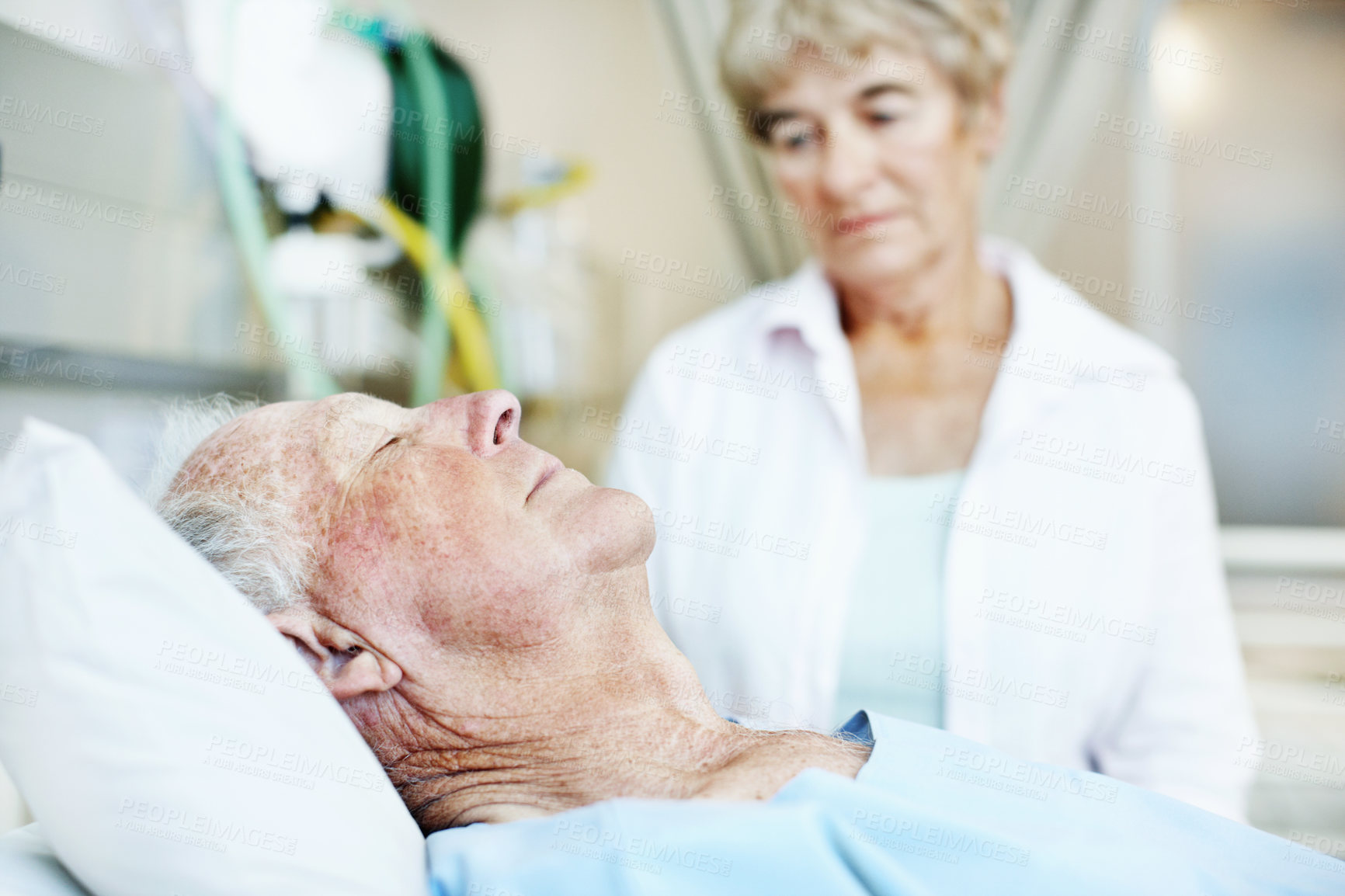Buy stock photo Worry, visit and wife of old man in hospital bed for medical recovery, surgery procedure and support. Healthcare diagnosis, coma and sad with elderly people in clinic for fear, relationship and grief