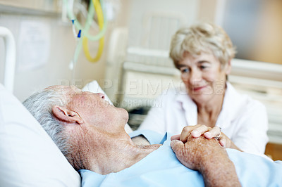 Buy stock photo Hospital bed, holding hands and senior couple for support, commitment and love for surgery recovery. Happy, healthcare and elderly man and woman with comfort, affection and care for wellness together