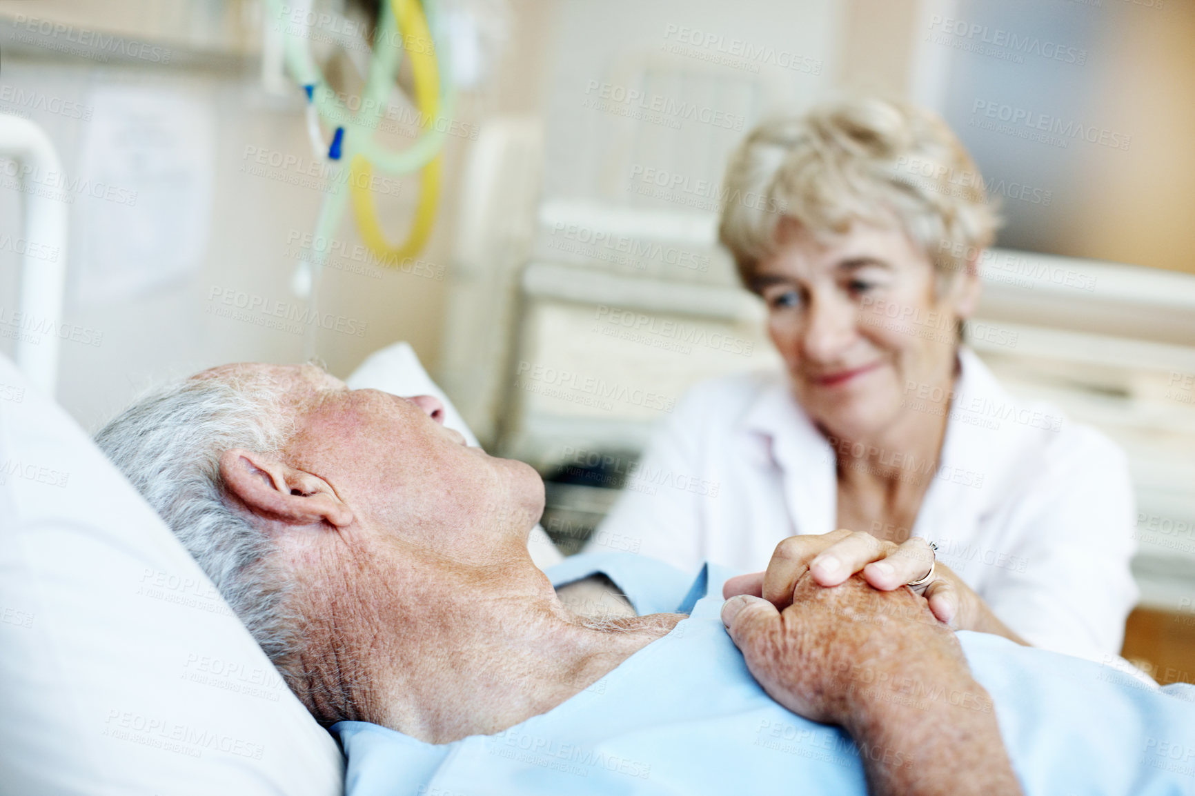 Buy stock photo Hospital bed, holding hands and senior couple for support, commitment and love for surgery recovery. Happy, healthcare and elderly man and woman with comfort, affection and care for wellness together