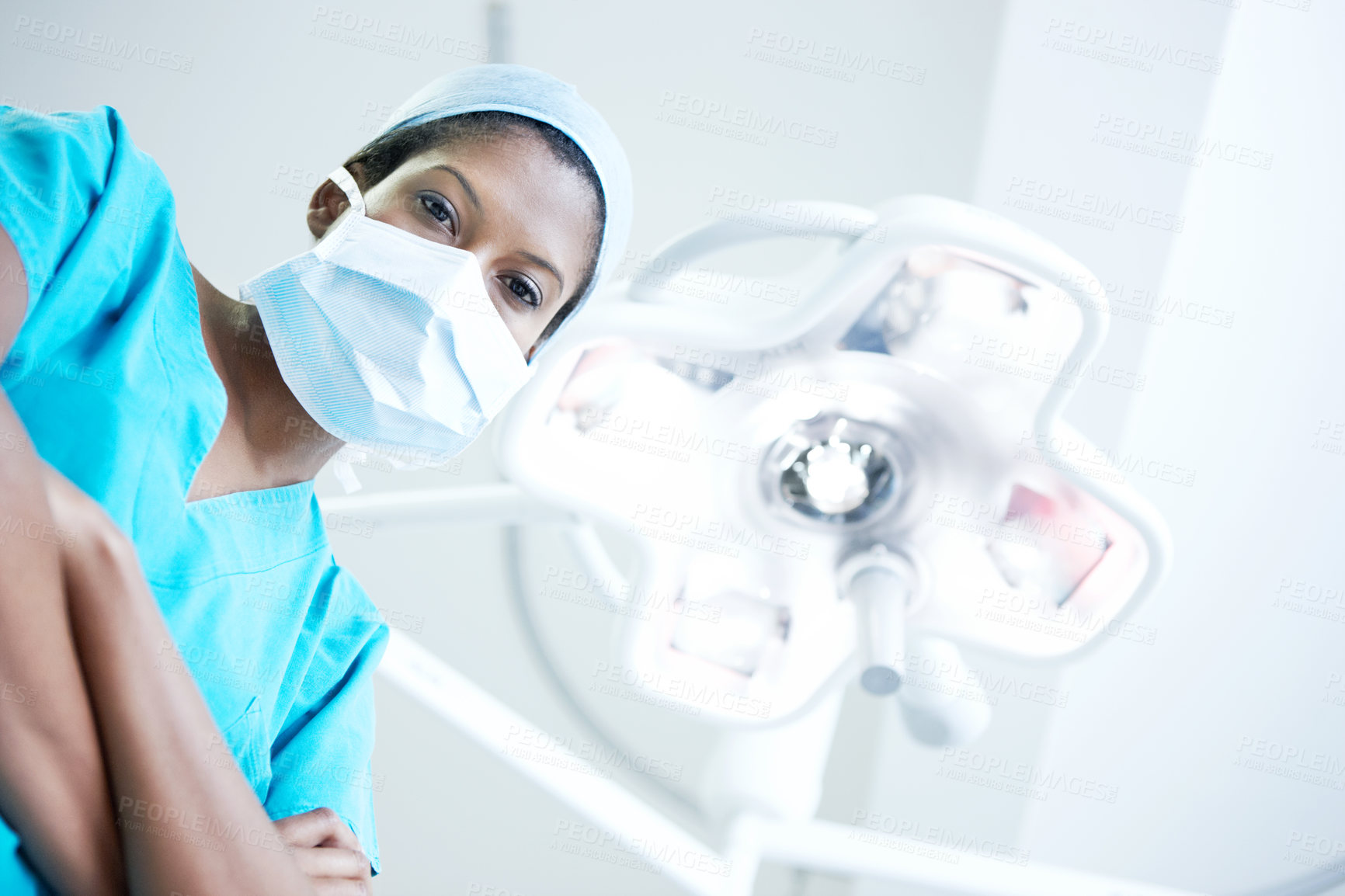 Buy stock photo Arms crossed, face mask and portrait of surgeon in hospital for operation, emergency room and accident. Healthcare treatment, pride and low angle with person in clinic for surgery, career and doctor