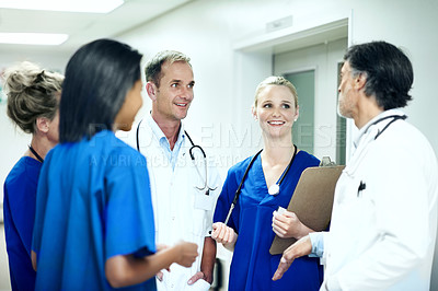 Buy stock photo Team, talking and consulting with doctors in hospital for healthcare, solidarity and meeting. Medical, community and discussion with group of people in hallway of clinic for support and collaboration