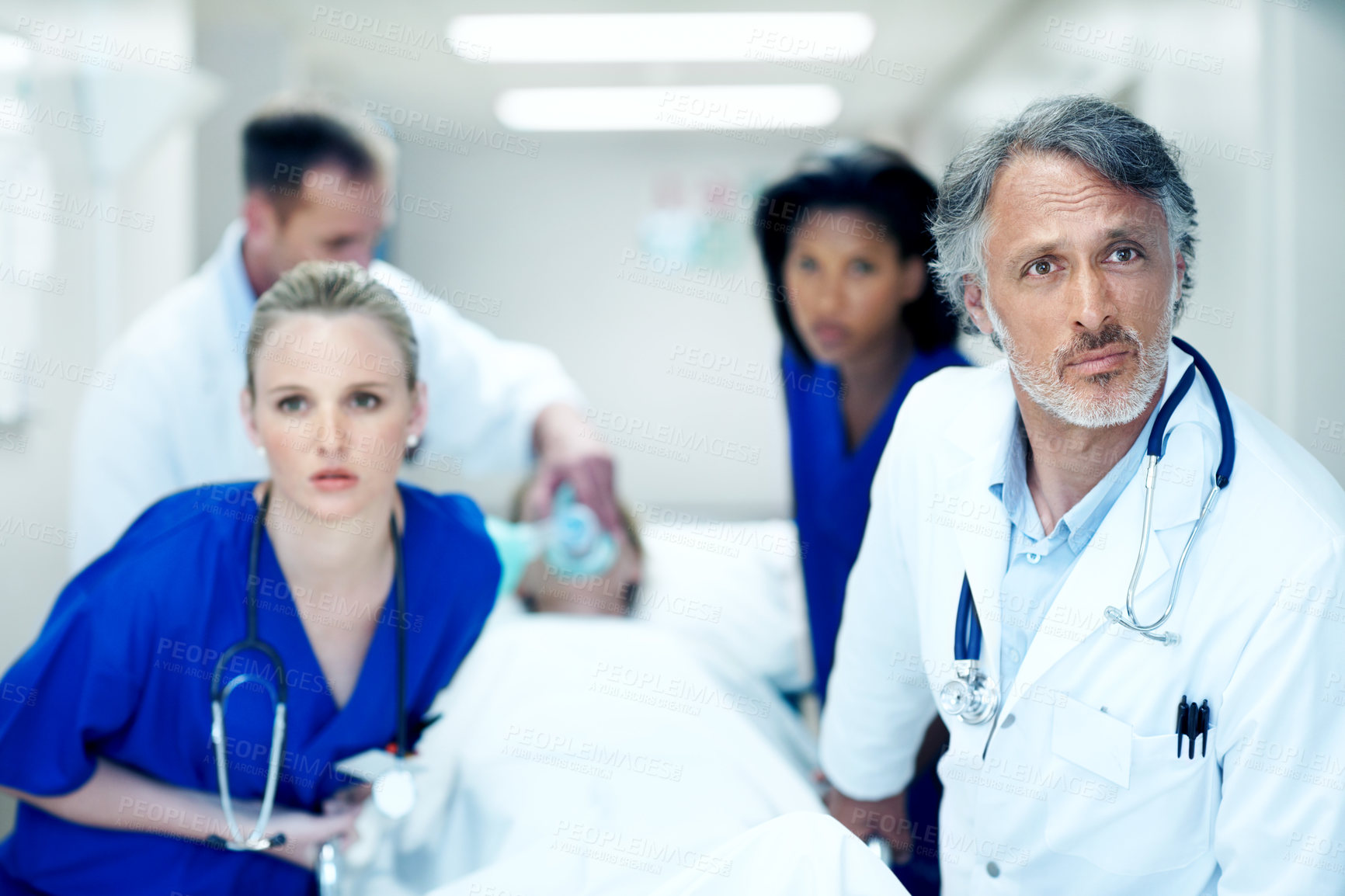 Buy stock photo Surgery, emergency and help with doctors in hospital for running, medical crisis and accident. Healthcare, injury and operation with people and patient in clinic for saving life, team and rush