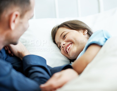 Buy stock photo Funny, father and sick child in hospital bed with laugh, connection and support for virus recovery. Man, happy daughter and dad joke in medical clinic with humor, empathy and assurance for healing.
