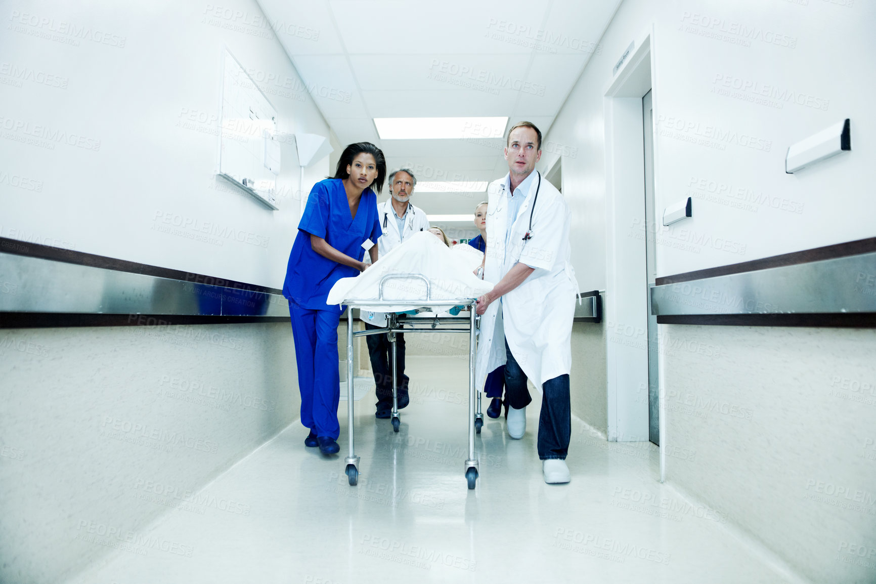 Buy stock photo Surgery, running and corridor with doctors in hospital for accident, medical crisis and emergency. Healthcare, injury and operation with people and patient in clinic for urgency, help and hallway