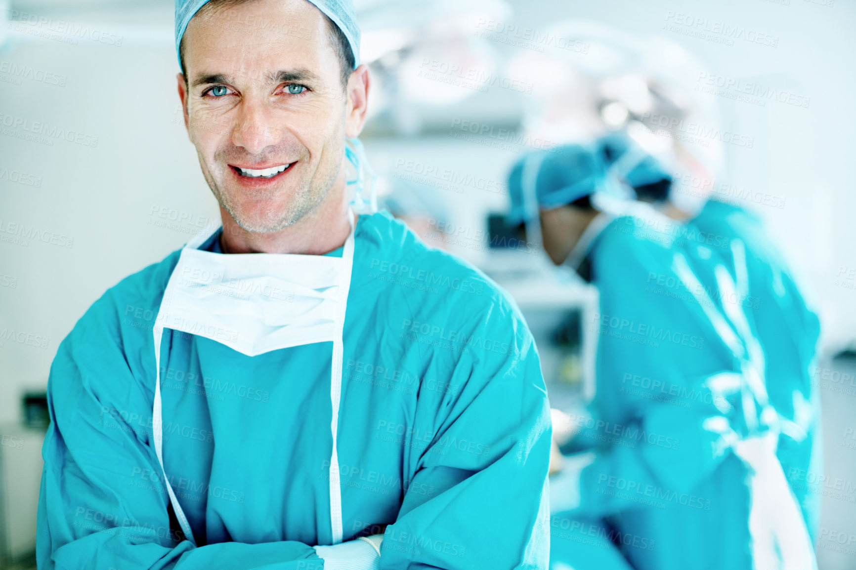 Buy stock photo Surgeon, health and man with arms crossed in theater for medical procedure, surgery leader or trust. Safety, doctor portrait or happy with staff in OR for healthcare operation, integrity or confident