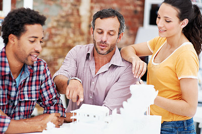 Buy stock photo Architect, team and talking with 3D model in meeting, brainstorming and real estate design in office. Architecture, designer and people with prototype, collaboration and property development ideas