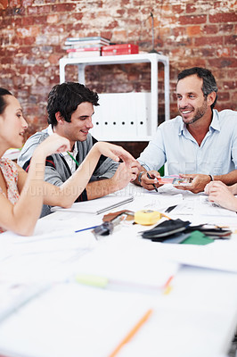 Buy stock photo People, team and conversation with swatch in office meeting for design, explain or review at media company. Employee, group and decision with document, feedback and collaboration at creative agency