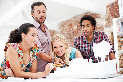 Buy stock photo Property development, review or people in agency with model, teamwork or design project in meeting. Building, smile or architects with prototype, site plan or group feedback in structure evaluation.
