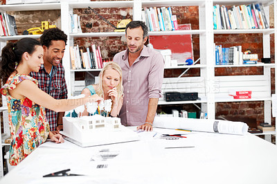 Buy stock photo Property development, meeting or people in agency with model, collaboration or feedback in design project. Building, teamwork or architects with prototype, site plan or group evaluation of structure.