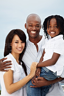 Buy stock photo Portrait of a smiling young family standing outside