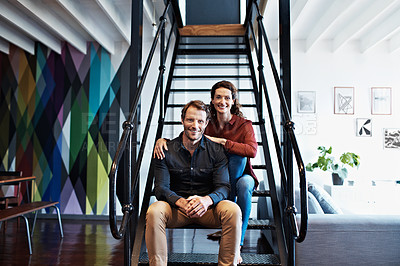 Buy stock photo Portrait of a smiling mature couple sitting on stairs in their loft