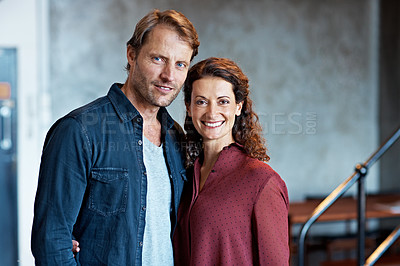 Buy stock photo Portrait of a smiling mature couple standing in their living room