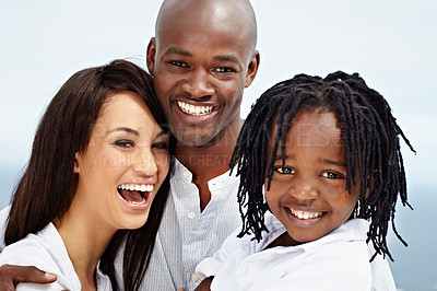 Buy stock photo Portrait of a laughing young family standing outside