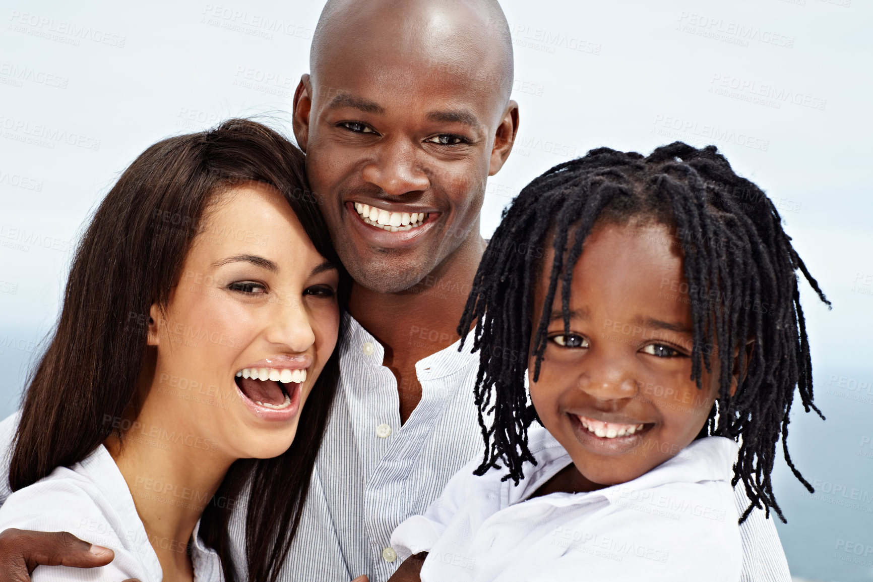 Buy stock photo Portrait of a laughing young family standing outside