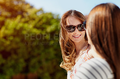 Buy stock photo Shot of two young friends enjoying a day outside together