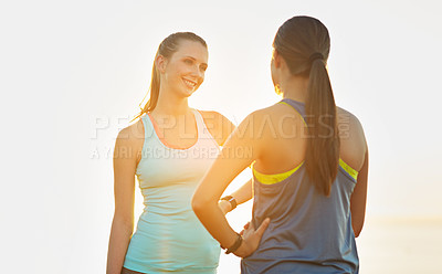 Buy stock photo Shot of two friends talking together after a cross country run