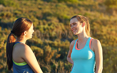 Buy stock photo Shot of two friends talking together after a cross country run