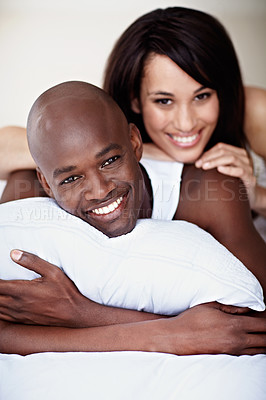 Buy stock photo Portrait of an affectionate young couple  lying in bed together