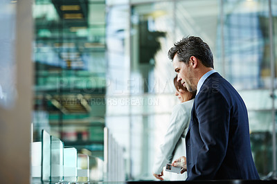 Buy stock photo Shot of businesspeople walking through the lobby of an office building