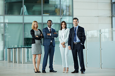 Buy stock photo Portrait of a group of businesspeople standing in the lobby of an office building