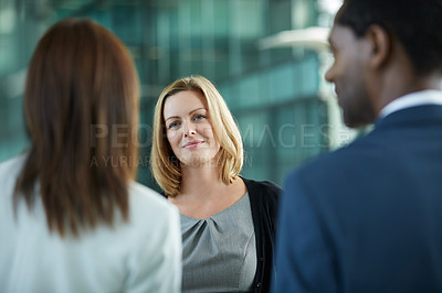 Buy stock photo Shot of businesspeople talking together in the lobby of an office building