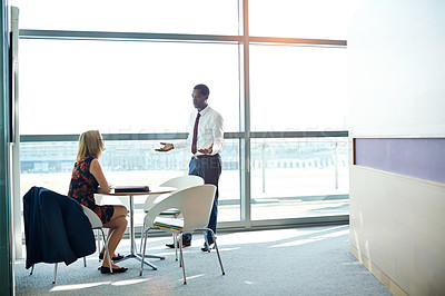 Buy stock photo Shot of two businesspeople having a meeting in an office