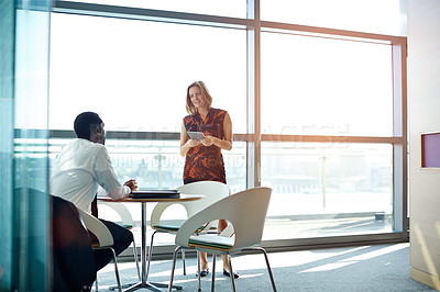 Buy stock photo Shot of two businesspeople having a meeting in an office