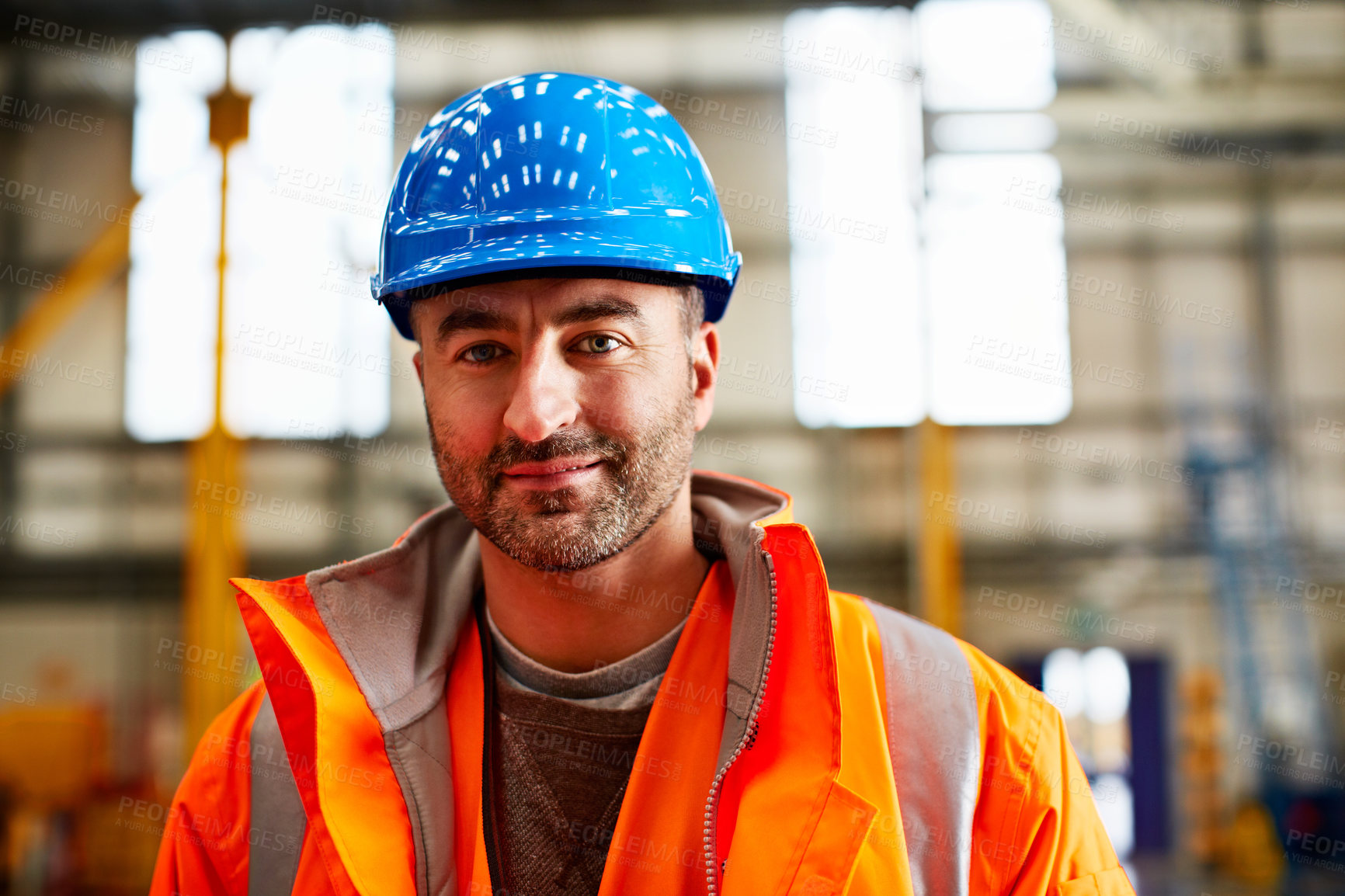 Buy stock photo Portrait of a man in workwear standing in a large industrial building