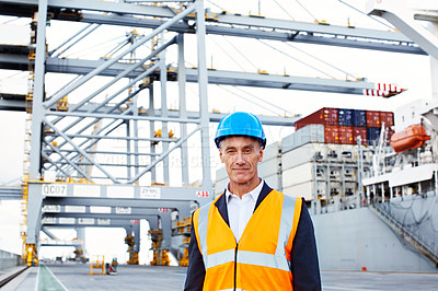 Buy stock photo Portrait of a mature man in workwear standing outside on a large commercial dock