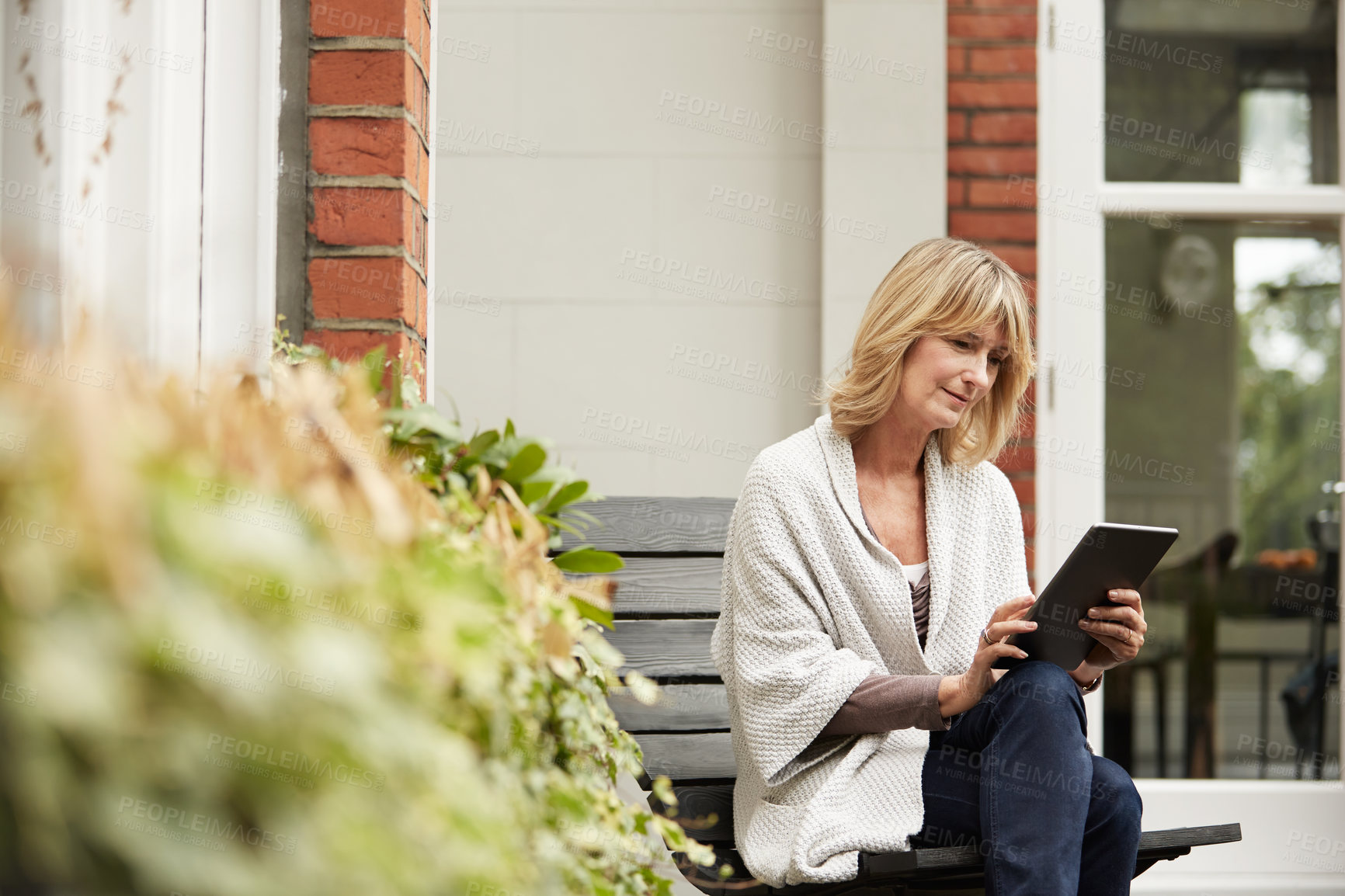 Buy stock photo Break, search and tablet with woman on bench in home garden for video recommendation or streaming. App, watching and relax with mature person outdoor for browsing, connectivity or subscription