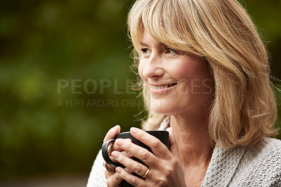 Buy stock photo Shot of a mature woman standing in her yard drinking a cup of coffee
