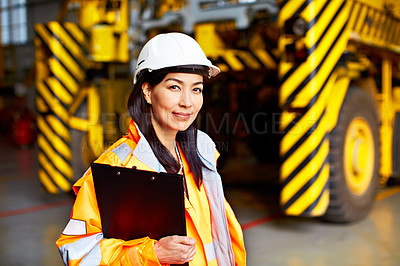 Buy stock photo Shot of a woman in workwear standing in a large industrial building