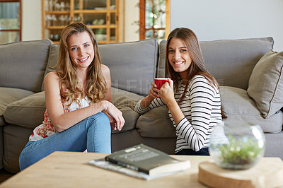 Buy stock photo Portrait of two friends sitting on the living room floor together
