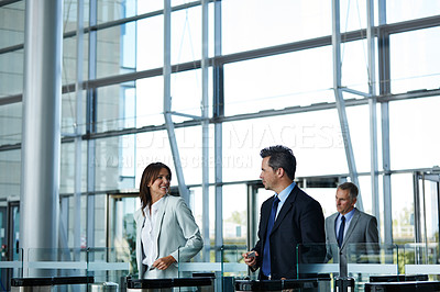 Buy stock photo Shot of businesspeople walking through the lobby of an office building