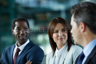 Buy stock photo Shot of businesspeople talking together in the lobby of an office building