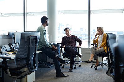 Buy stock photo Shot of a group of businesspeople talking in the office