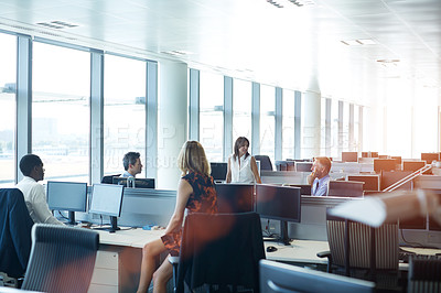 Buy stock photo Shot of a group of businesspeople talking in the office