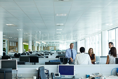 Buy stock photo Shot of a group of businesspeople talking in the office