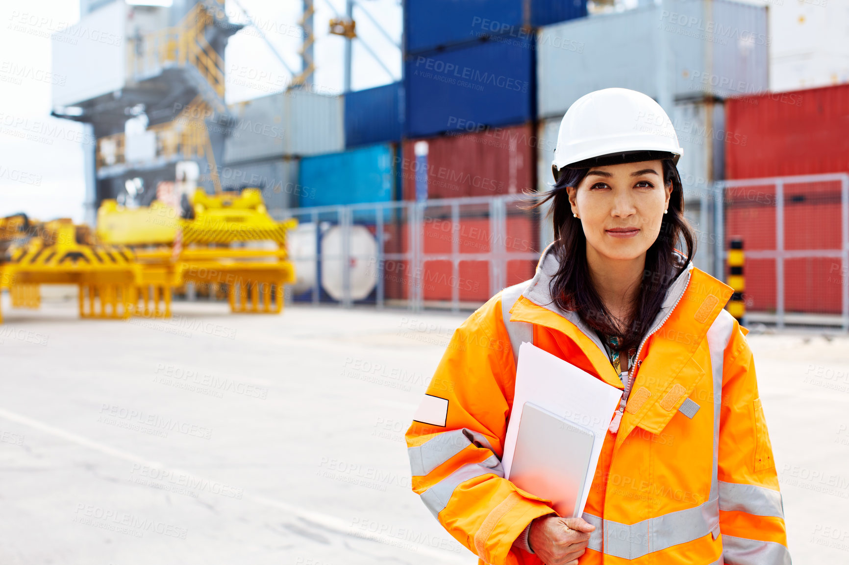 Buy stock photo Portrait of a woman in workwear standing on a commercial dock