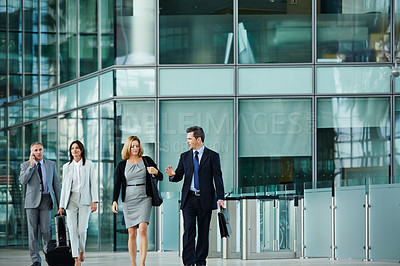 Buy stock photo Shot of businesspeople walking through the lobby of an office building