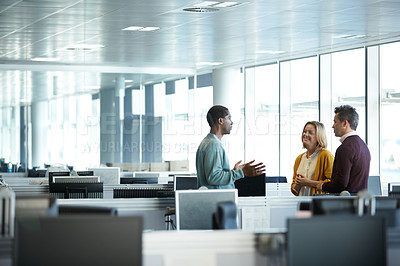 Buy stock photo Shot of a group of businesspeople talking together in the office