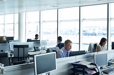 Buy stock photo Shot of businesspeople working at their desks in an office