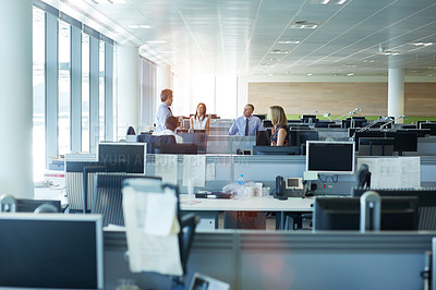 Buy stock photo Shot of a group of businesspeople talking together in the office