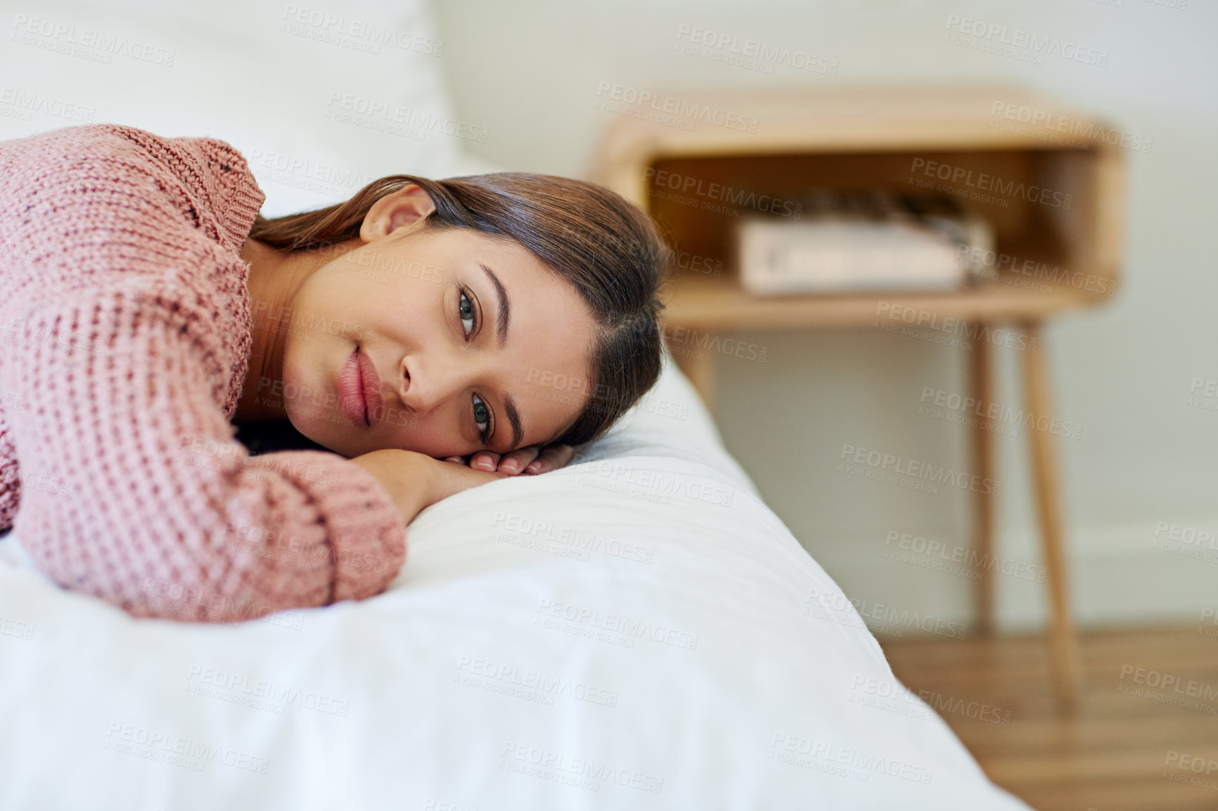 Buy stock photo Portrait of a young woman lying on her bed