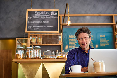 Buy stock photo Portrait of a man sitting in a cafe bakery working on a laptop