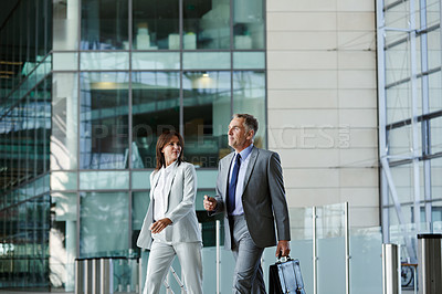 Buy stock photo Shot of businesspeople walking through the lobby of an office building