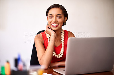 Buy stock photo Portrait of a young woman working on a laptop in an office
