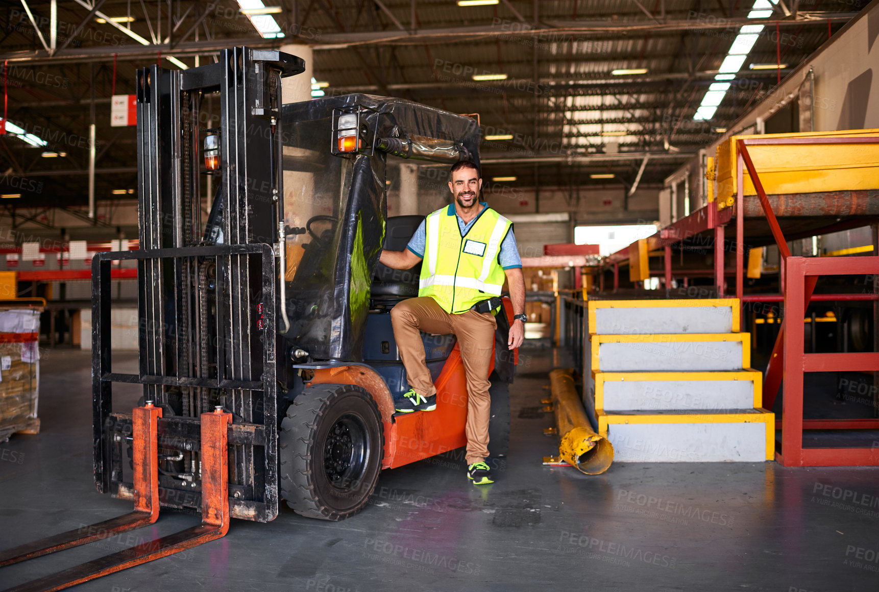 Buy stock photo Portrait of smiling forklift operator in a large warehouse
