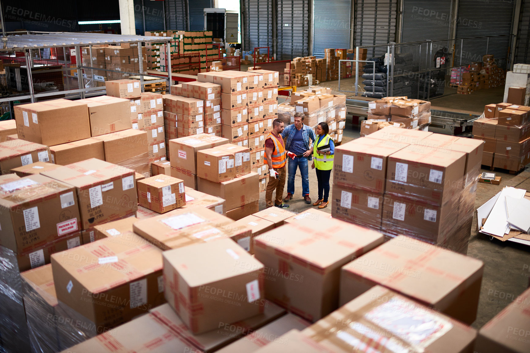 Buy stock photo Team, above and people in warehouse with package, boxes and stock for shipping distribution. Factory, logistics and worker meeting with supervisor for delivery, supply chain and inventory management