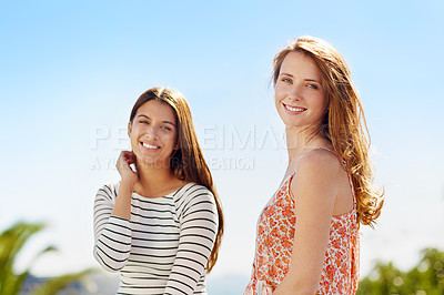 Buy stock photo Portrait of a two friends standing outside on a summer day